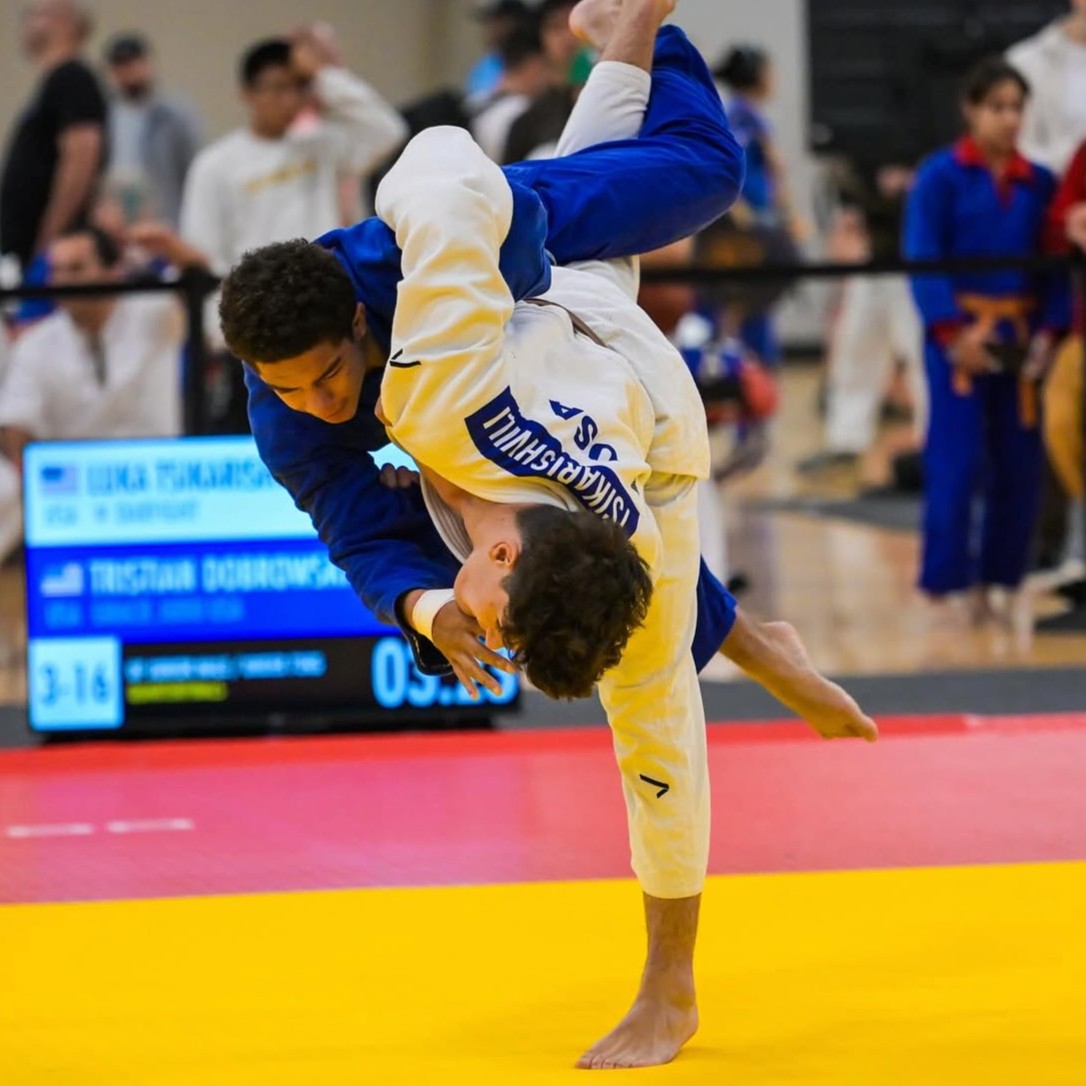 Teen judo athletes mid-throw during a competition at Darfight Judo.