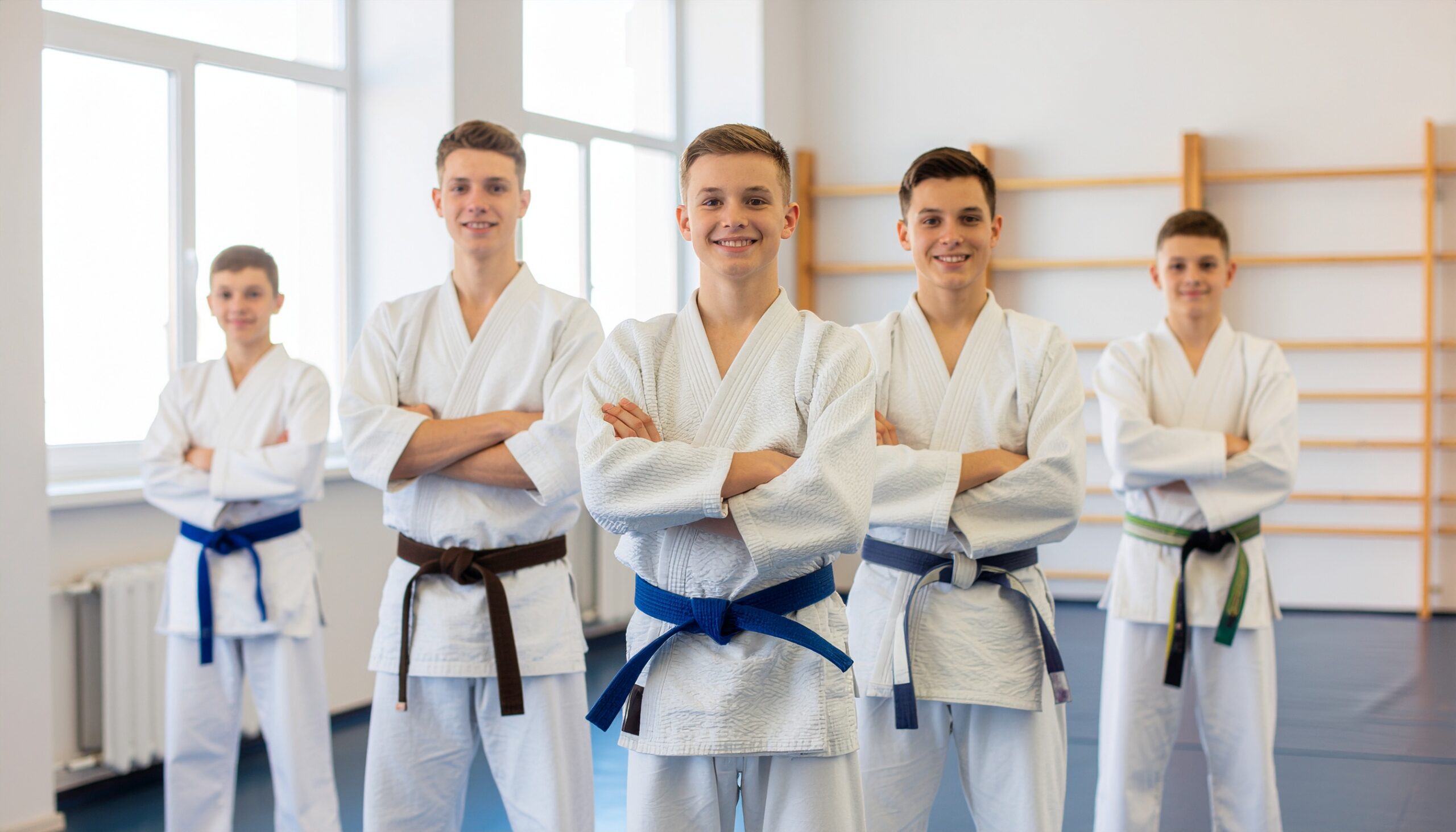Group of teenage boys in Judo uniforms, posing confidently in Darfight’s Brighton Beach dojo